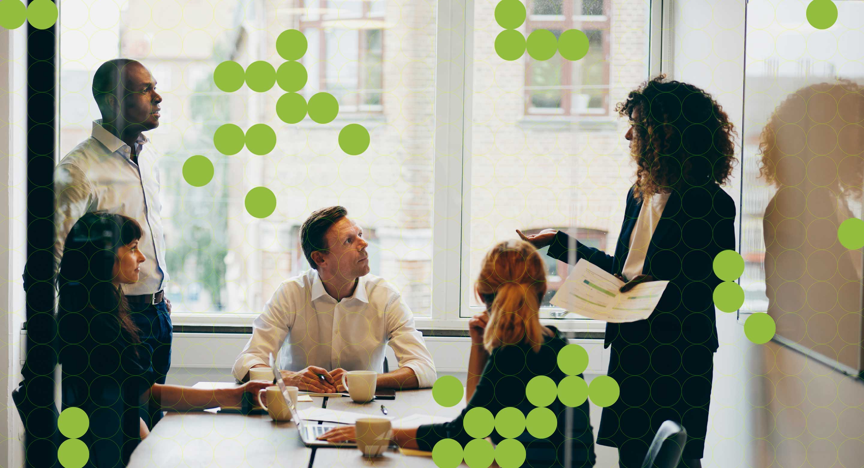 A team gathers in a conference room, discussing business.