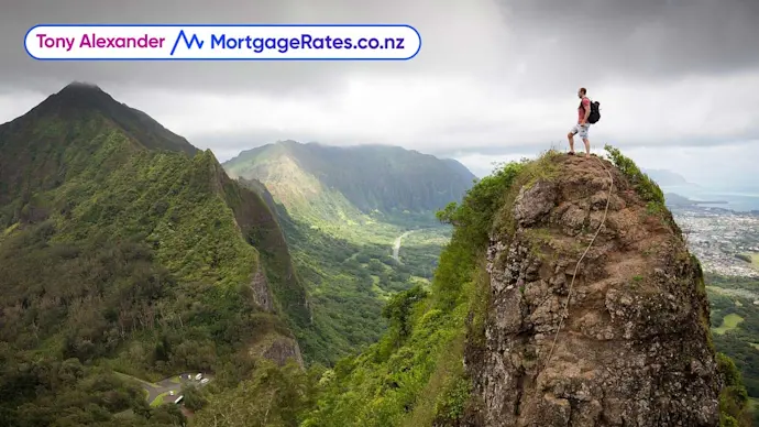 Person standing on peak of mountain