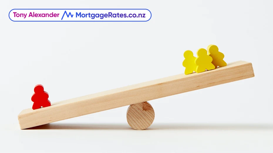 People-shaped blocks on a wooden seesaw