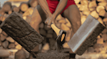Close up shot of a man chopping wood