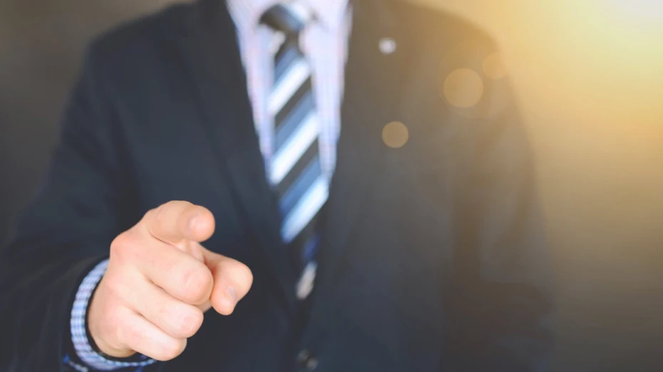 Cropped image of corporate banker, pointing finger