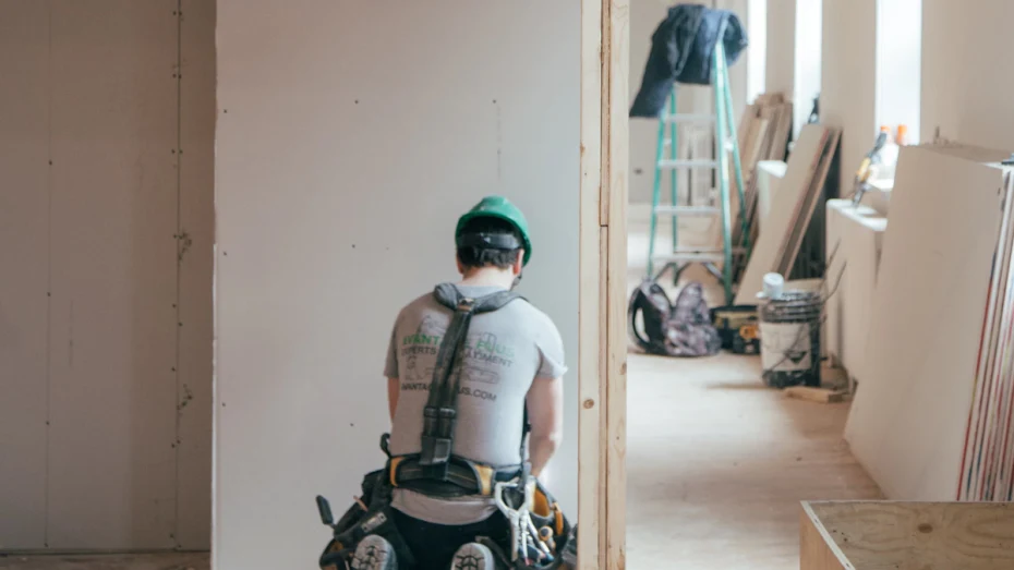 Back of builder inside house under construction