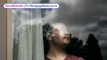 Man looking out window