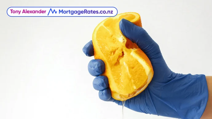 Hand in glove squeezing lemon