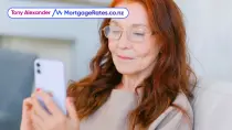 Middle aged woman looking at phone, smiling