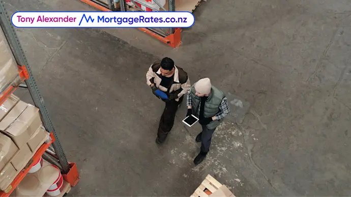 Two men walking around factory