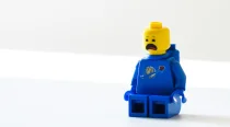 Surprised-looking yellow lego man in a blue outfit