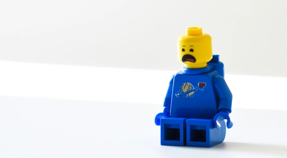 Surprised-looking yellow lego man in a blue outfit