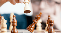 Close-up shot of a checkmate move in chess, knocking the king down. 