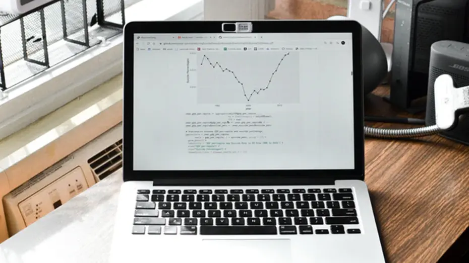 Laptop on home office desk with graph on screen