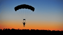 Parachuter coming in to land at sunset