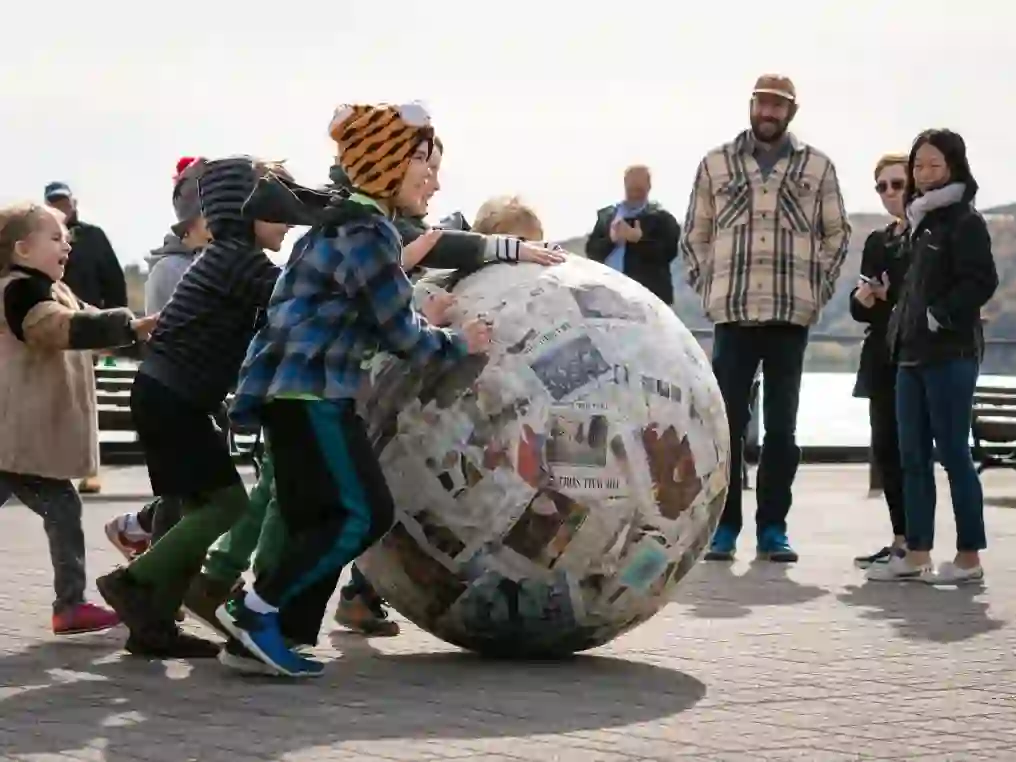 Children rolling Michelangelo Pistoletto's 'Sfera di Giornali', 1966-2017 down the Hudson River waterfront