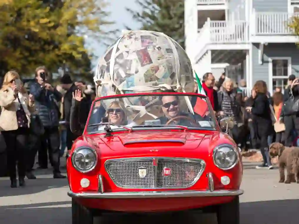 Magazzino co-founder Nancy Olnick rides away with Michelangelo Pistoletto's 'Sfera di giornali' after the "Walking Sculpture" Performance