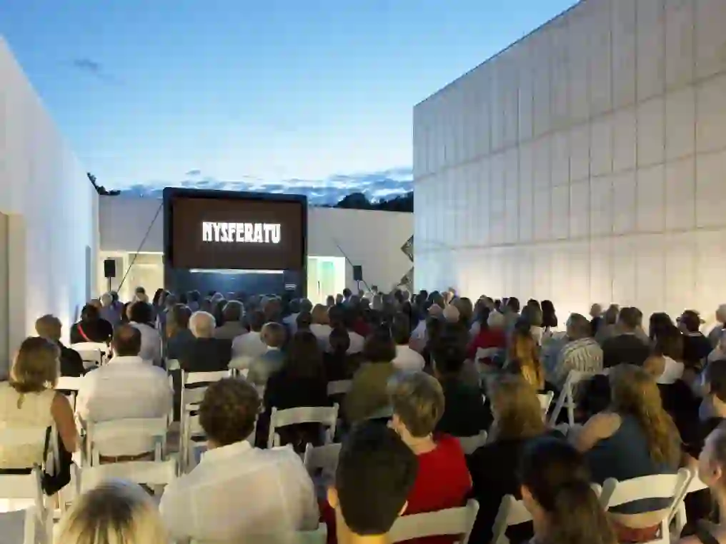 The crowd takes their seats in Magazzino's courtyard for the outdoor screening of "NYsferatu: Symphony of a Century" by Italian artist Andrea Mastrovito.