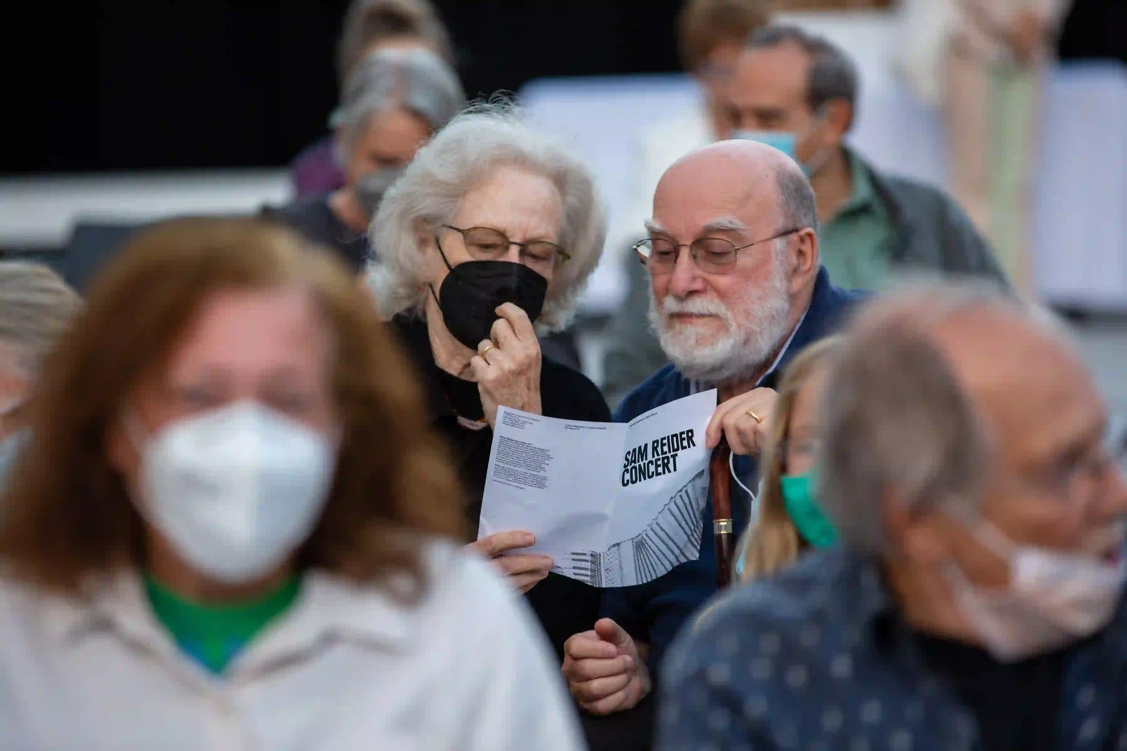 Couple reading leaflet for the Sam Reider and the Human Hands concert, 2011