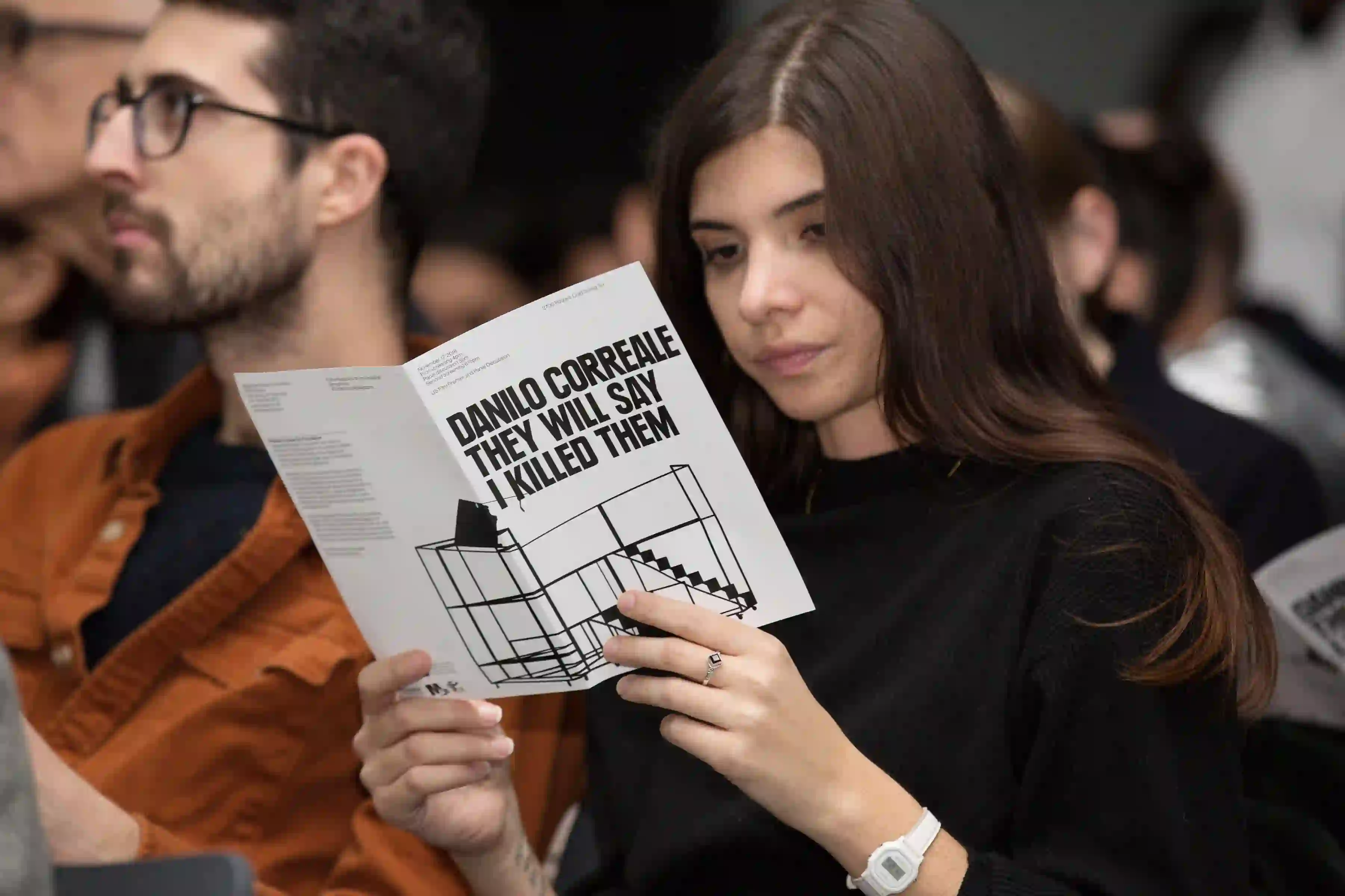 Screening of Diranno che li ho uccisi io by Danilo Correale, girl reading leaflet