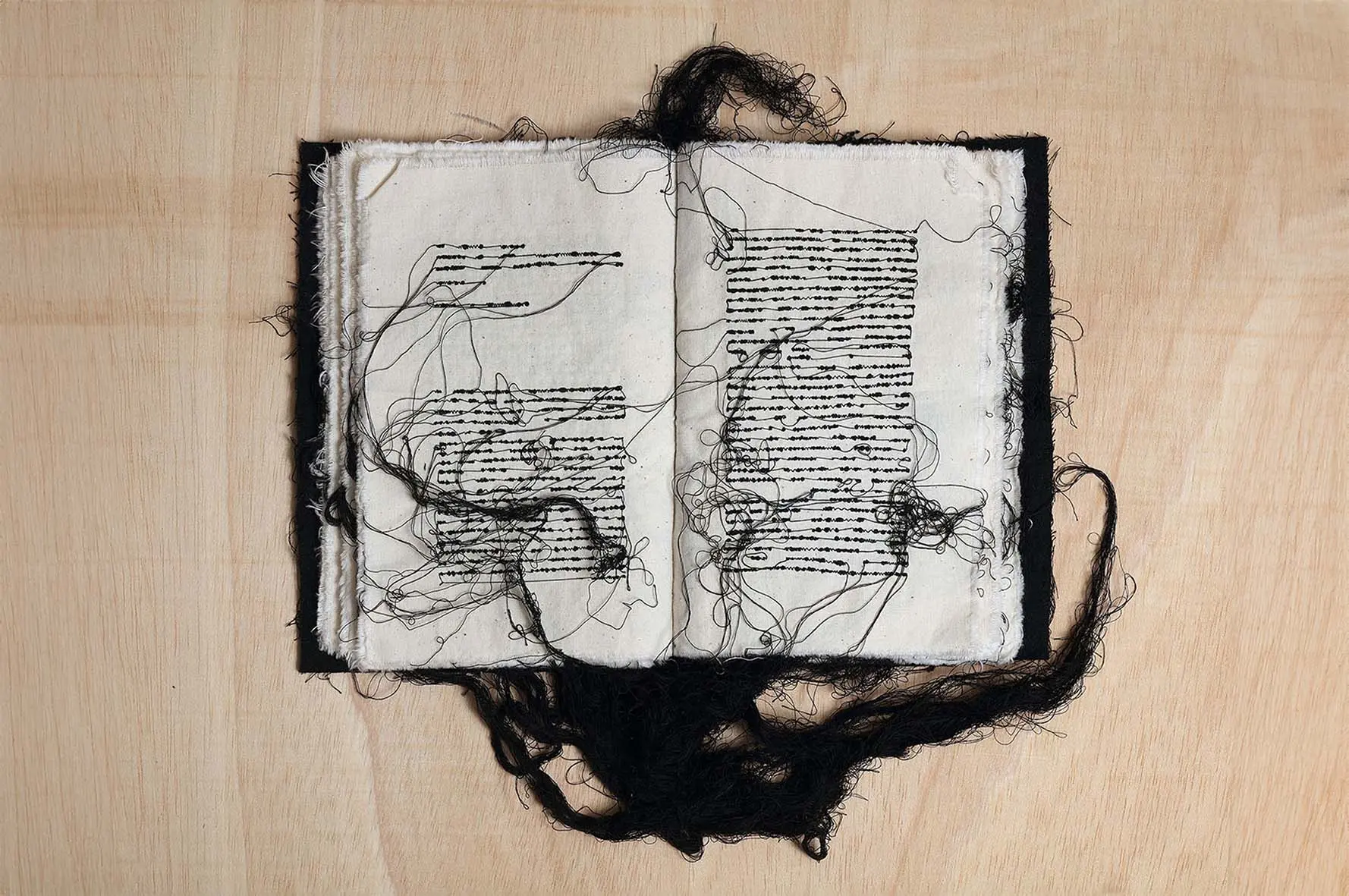 Maria Lai, "Voce di infinite letture," 1992. Cotton thread, ink, canvas. 9 7/8 x 10 1/4 x 2 in. (25 x 16 x 5 cm). Magazzino Italian Art Foundation, Photo by Marco Anelli. ©2024 Artists Rights Society (ARS), New York/SIAE, Rome