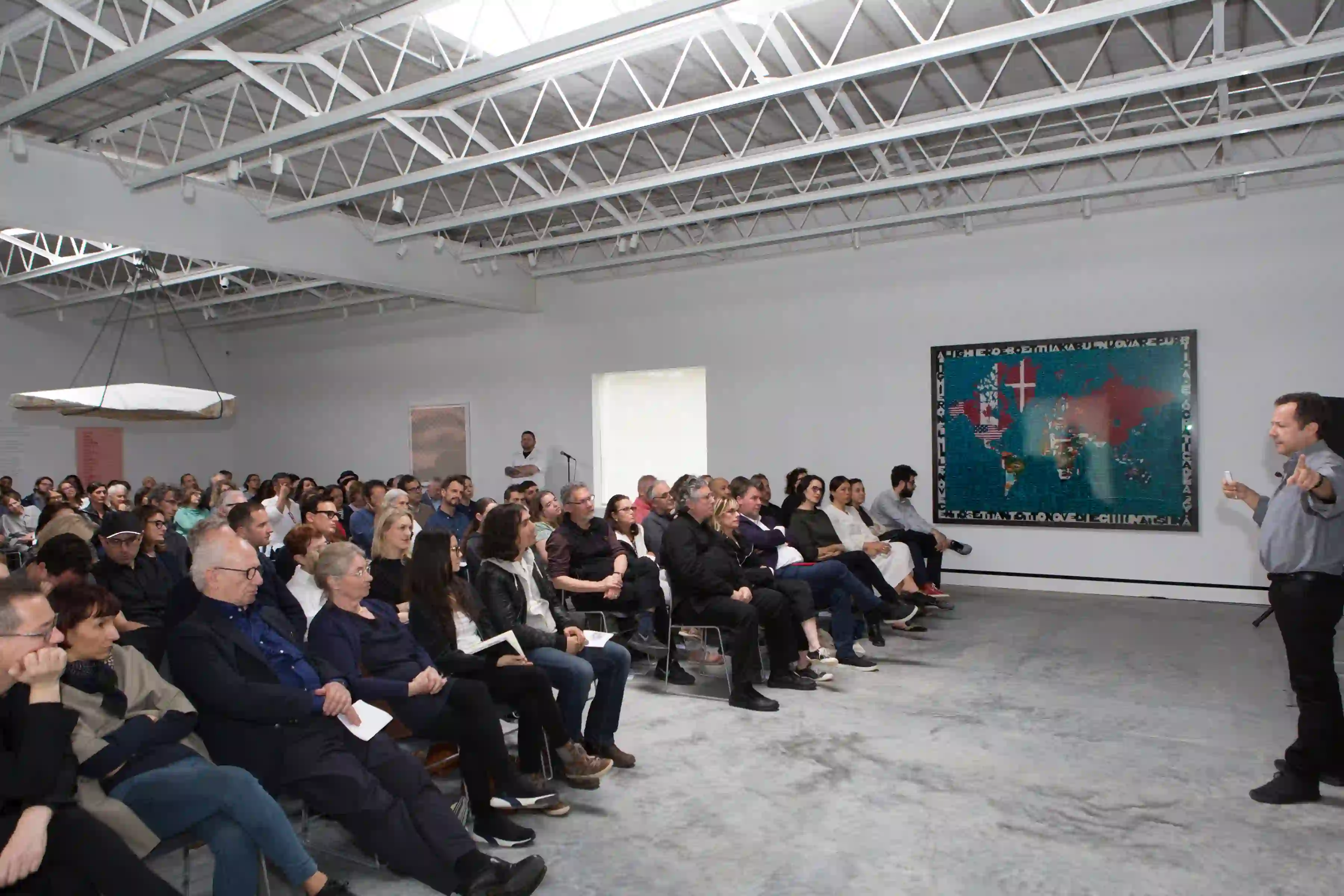 Vik Muniz speaks to the audience at Magazzino Italian Art Foundation