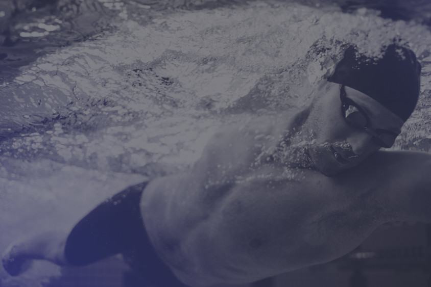 Closeup of a swimmer in doing laps in a pool.