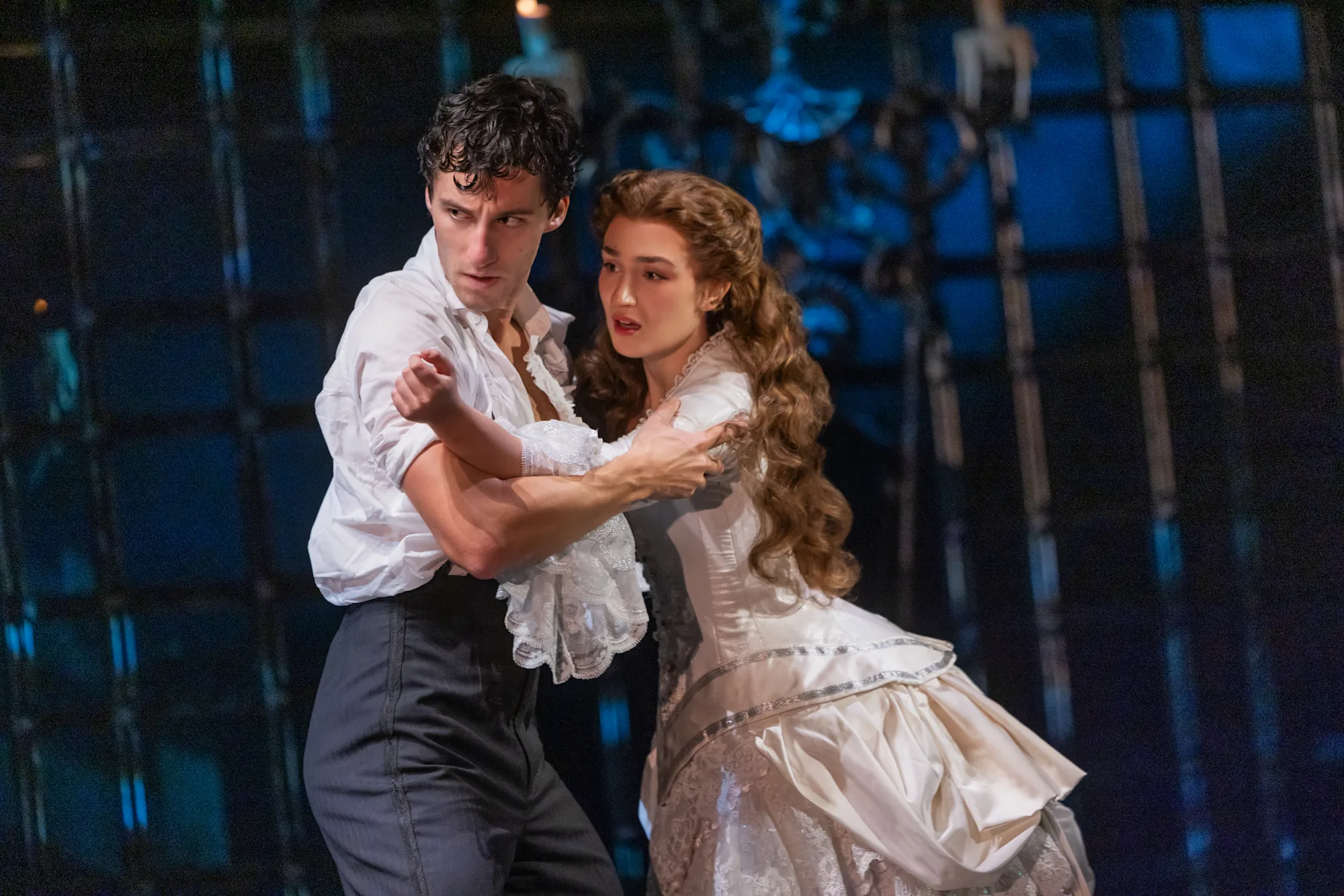 (L to R) Daniel Lopez as Raoul, Vicomte de Chagny and Jordan Lee Gilbert as Christine Daaé in The Phantom of the Opera North American Tour Photo: Matthew Murphy and Evan Zimmerman; Raoul and Christine embrace, reading themselves for something to come for them.