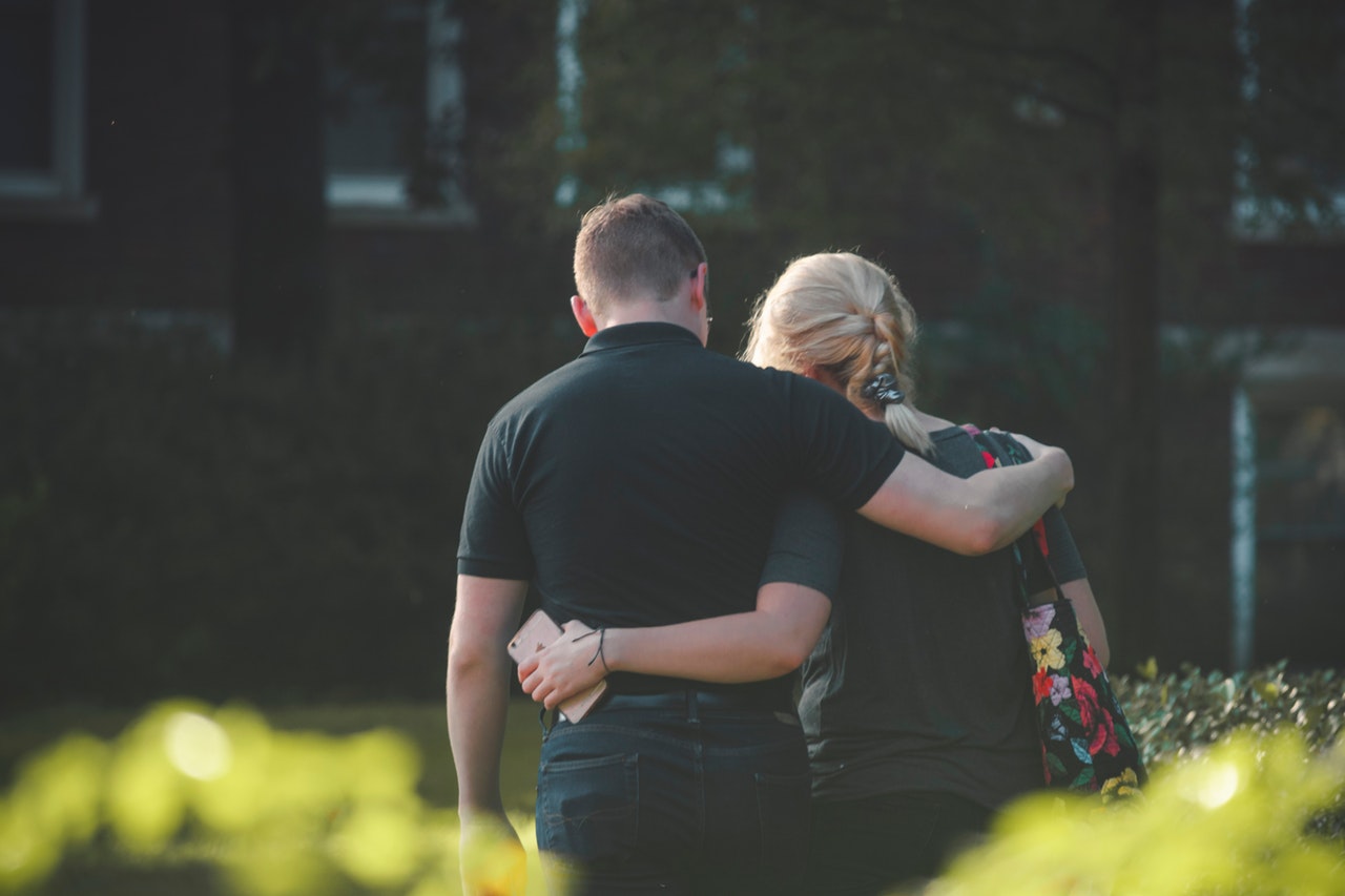 couple-walking-toward-building-1487076