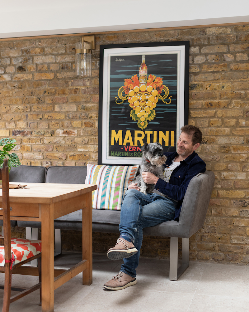 Resi customer, David, relaxes with his pooch in his newly renovated kitchen with subtle cottage design elements