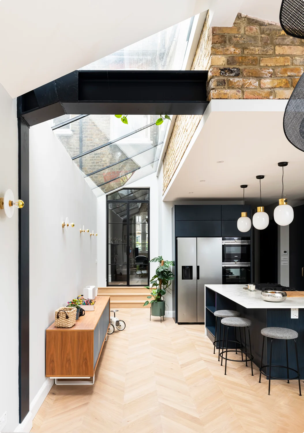 Indoor glass walls create an elegant broken-plan layout