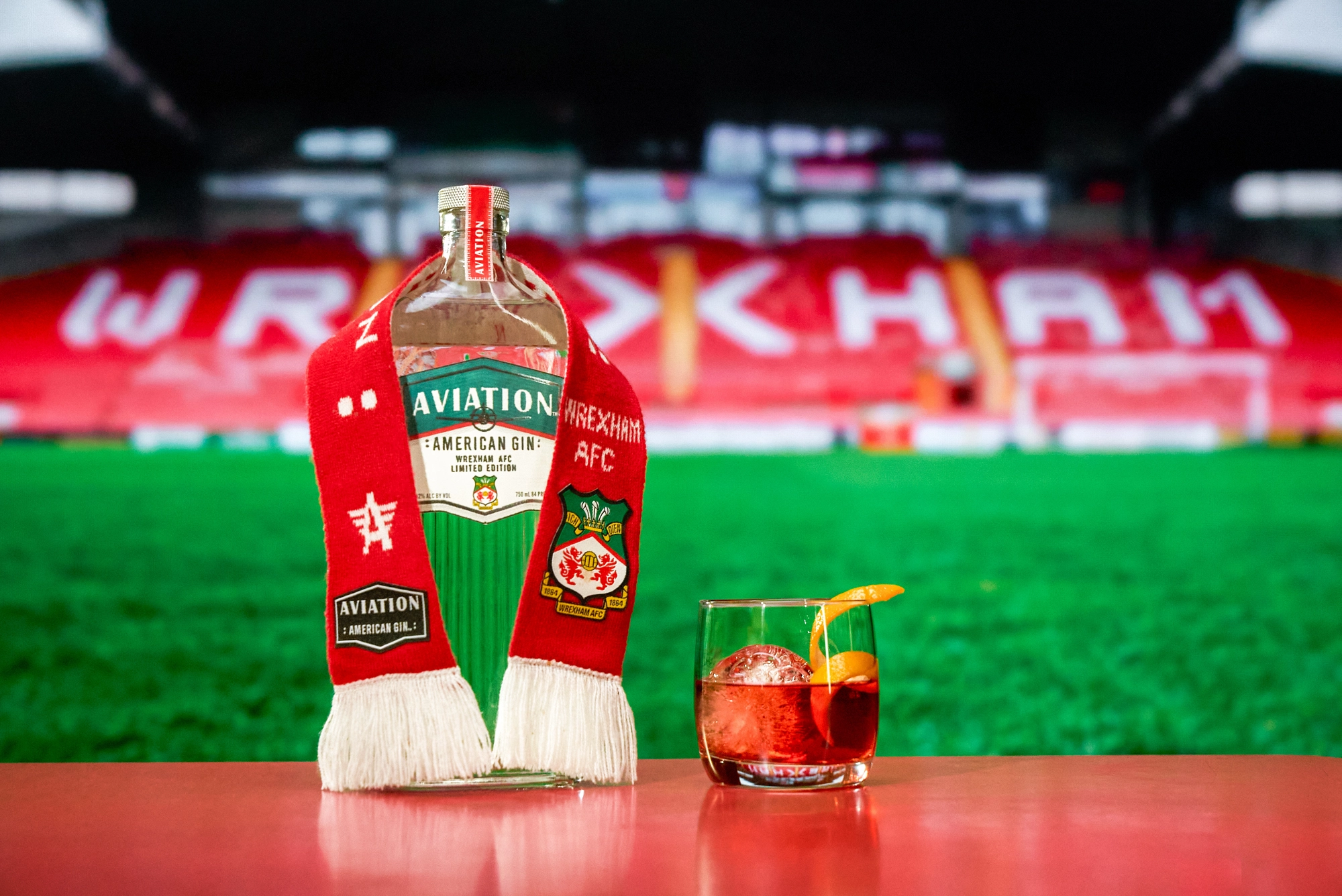 Aviation Gin: Wrexham Limited edition bottle with glass of cocktail with scarf on bottle
