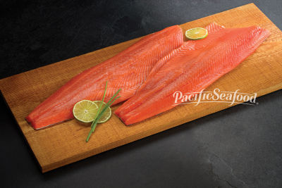 Two Pacific Seafood fish filets on a cutting board with lime and chive garnish