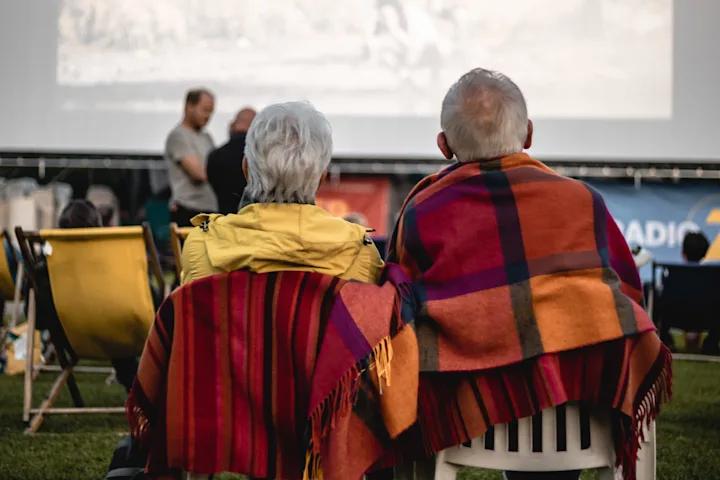 Pärchen sitzend vor der Leinwand im Open Air