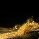 hier sieht man goldenen staub auf schwarzem hintergrund