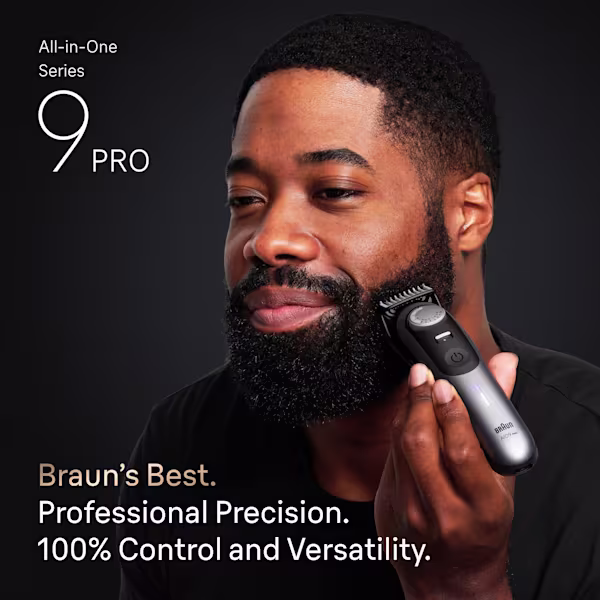Young man trimming his beard with Series 9 PRO All in One Trimmer Series.