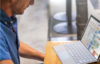 Man looking at a laptop computer on a desk