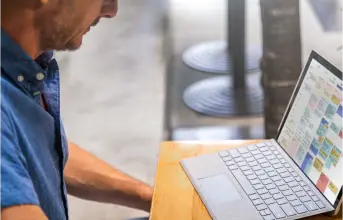 Man looking at a laptop computer on a desk