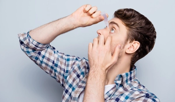 Глазные капли могут помочь при гиперемии конъюнктивы Мужчина использует глазные капли от покраснения