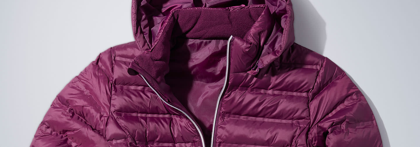 A burgundy down jacket on a white table