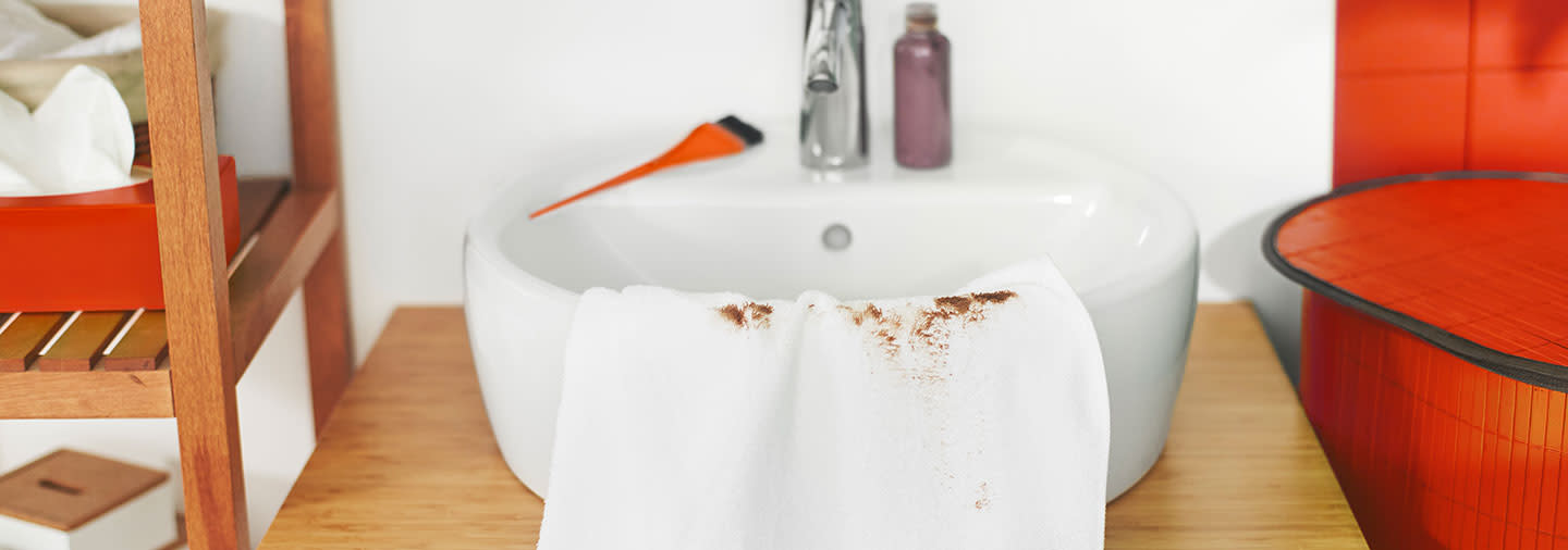 White towel stained with hairdye in the sink