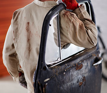 A man in rust-stained work clothes