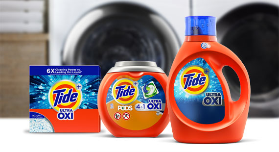 Tide powder, PODS and liquid products in front of a washer
