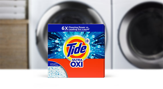 Tide powder detergent products in front of a washing machine