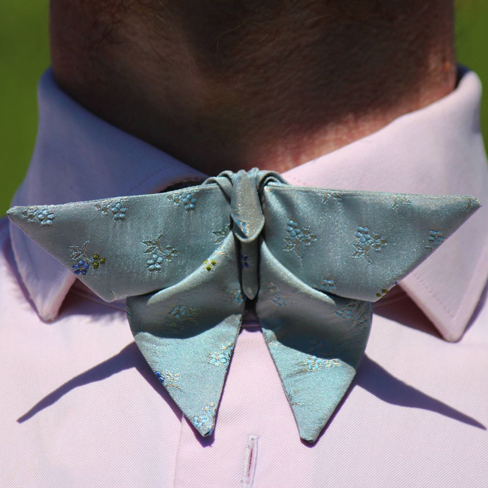 Detail of an origami butterfly bow tie in colour of Forget-me0nots