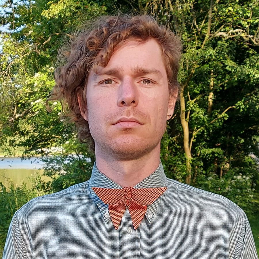 A ginger man wearing silk origami butterfly bow tie