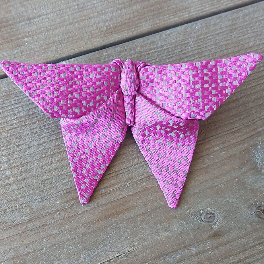 Close up of a purple origami butterfly bow tie
