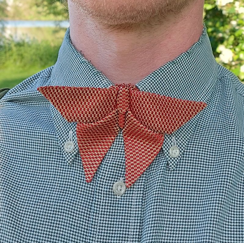 Closeup of a red and yellow silk origami butterfly bow tie