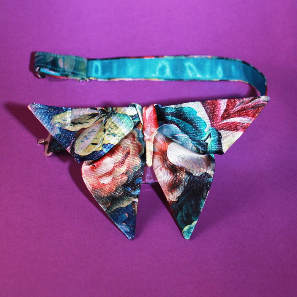 Detail of a Satin origami bow tie with floral pattern and satin ribbon on the neck tape