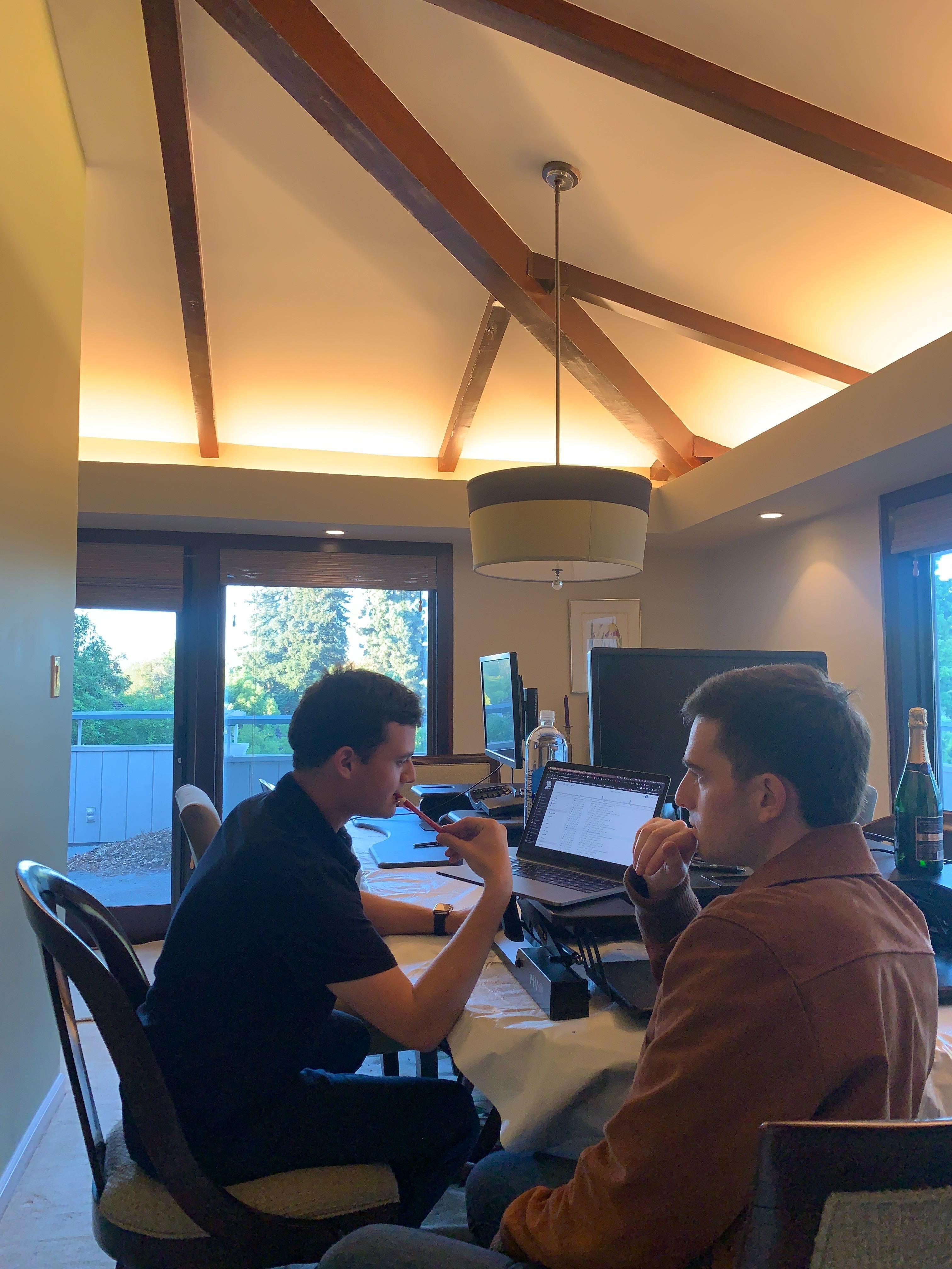 Skiff co-founders work together at a table with laptops