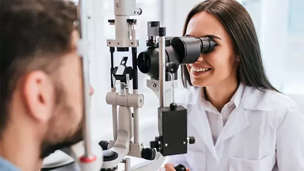 Optometrist checking someone’s eyes with a machine  