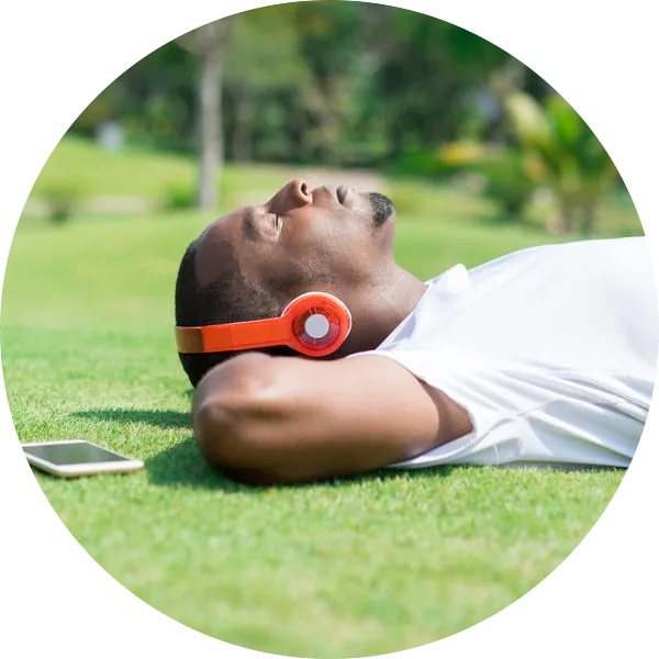 Man resting in park wearing headphones
