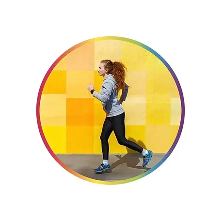 Side view of female athlete running against bright colorful wall 