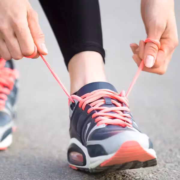  Woman tying shoelaces before running 